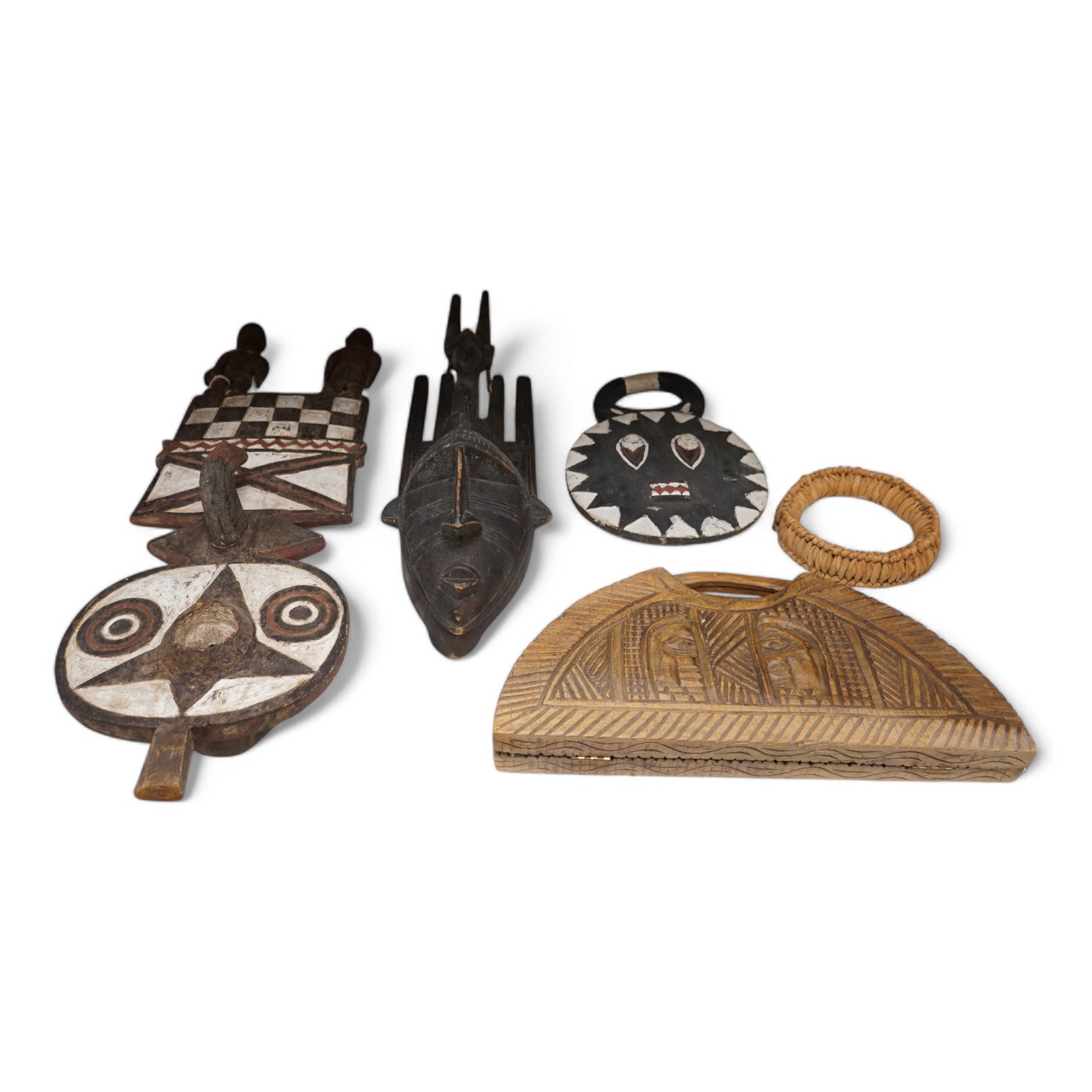 Three African tribal masks and a carved folding tray, largest 92cm. Condition - fair to good